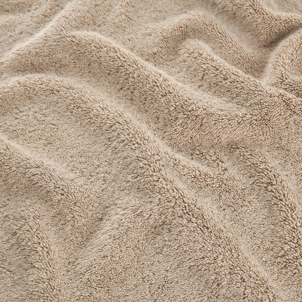 Conjunto de toallas de bambú beis con detalle de textura suave de toallas de cara, mano y baño