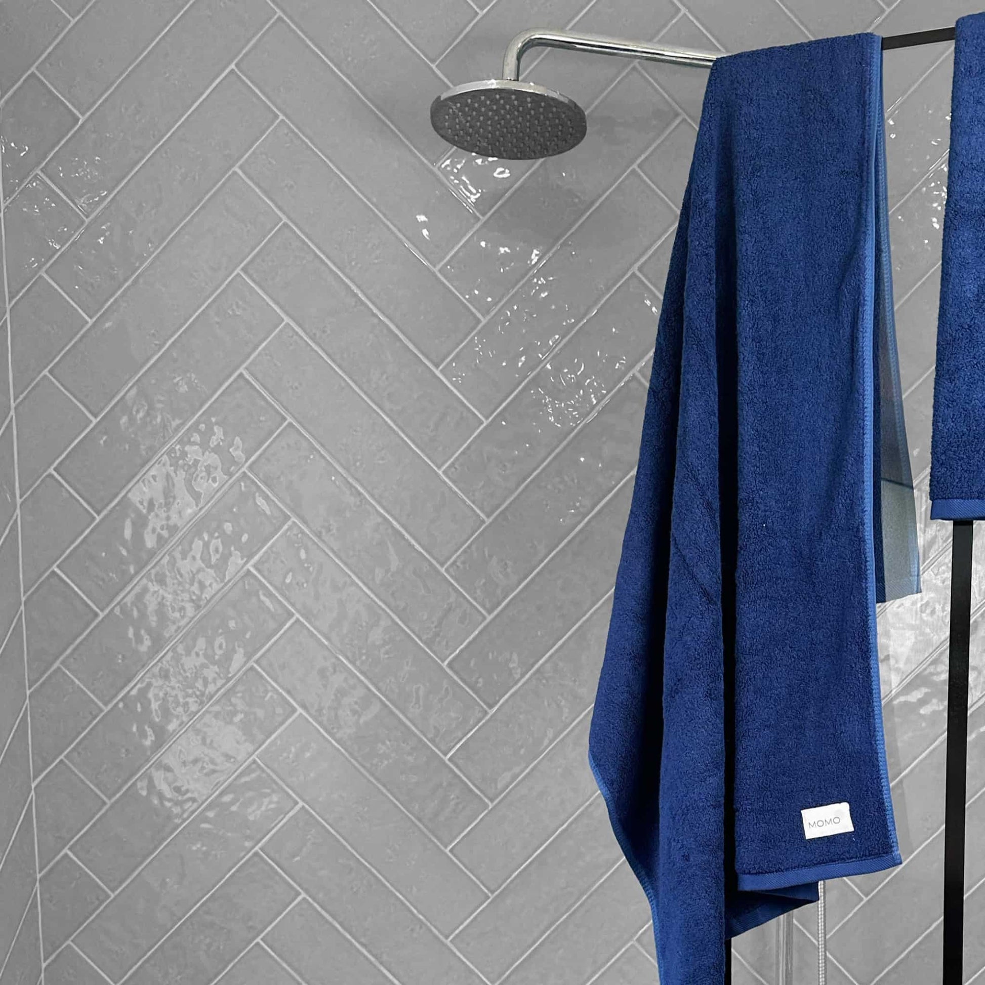 Blue bamboo bath towel on grey background – soft, absorbent and sustainable