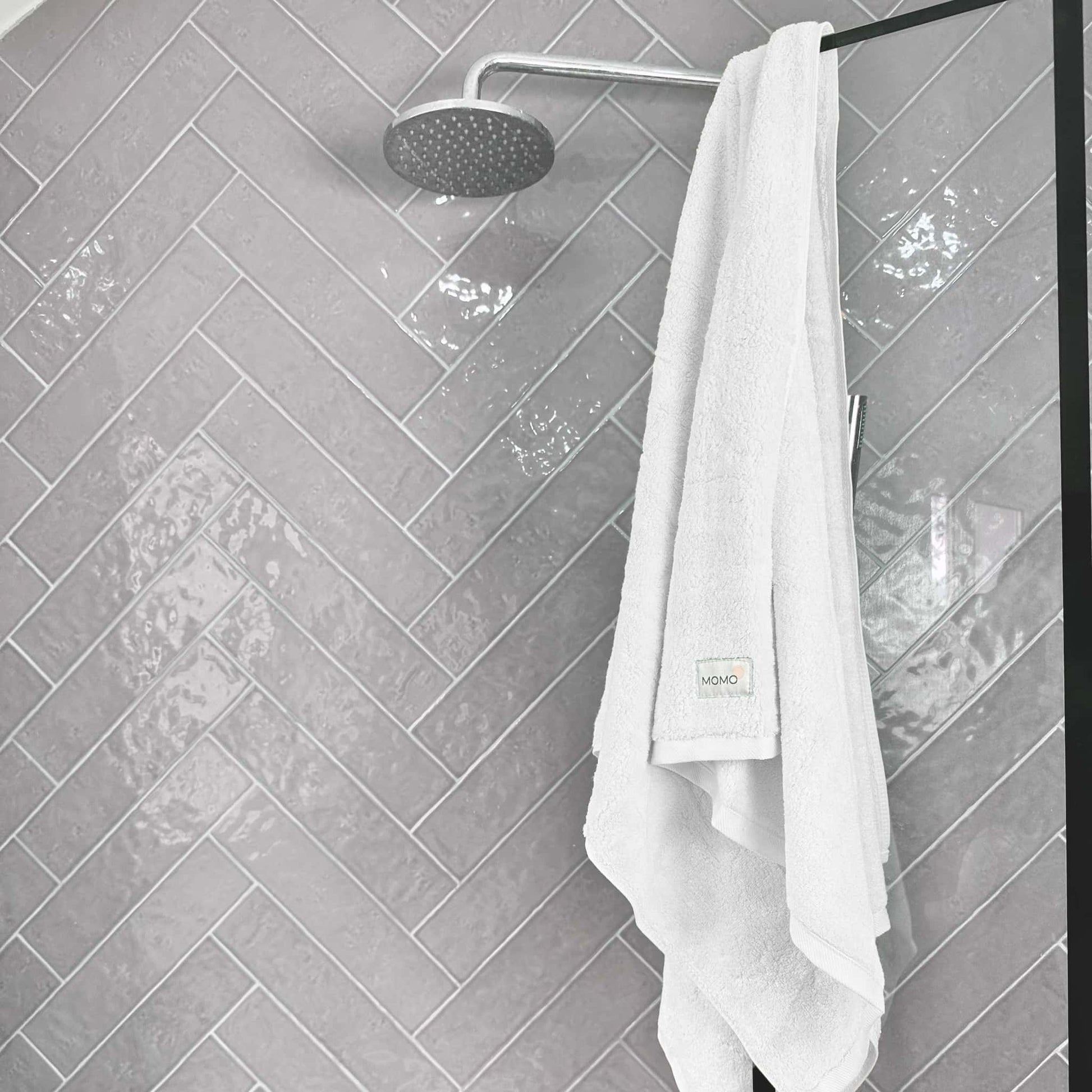 White bamboo bath towel on grey background – soft, absorbent and sustainable