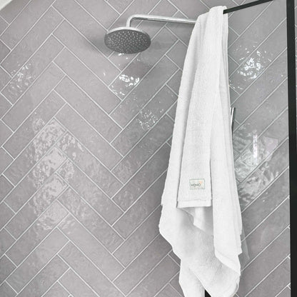 White bamboo bath towel on grey background – soft, absorbent and sustainable