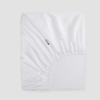 Sábana bajera ajustable blanca bambú de Momo Cotton – tejido satén 300 hilos, suave, transpirable y sostenible.