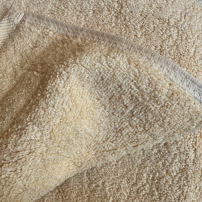 Close-up of beige bamboo towel seams texture – soft, absorbent and sustainable