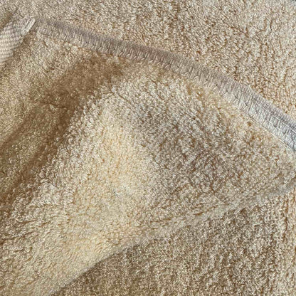 Close-up of beige bamboo towel seams texture – soft, absorbent and sustainable