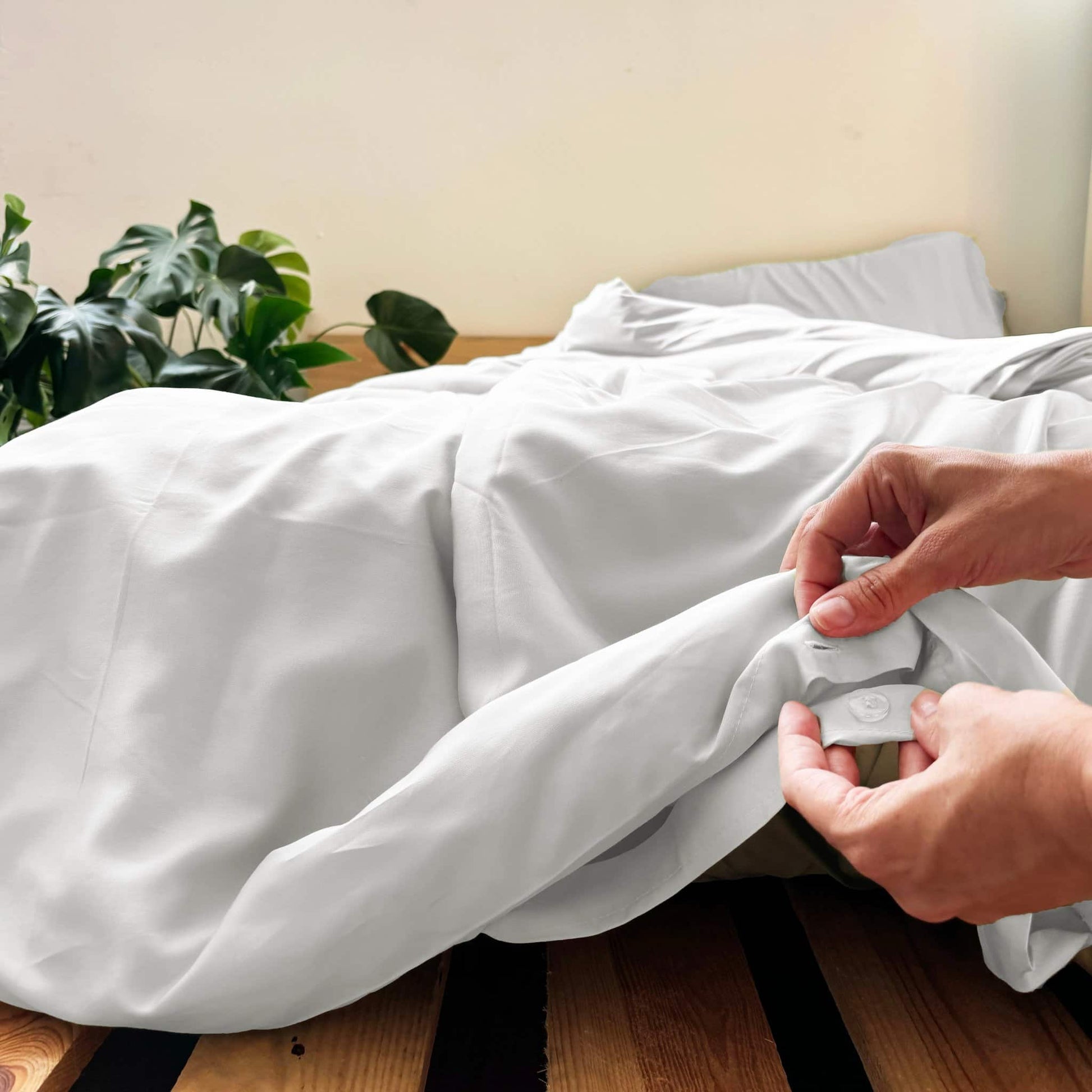 Close-up of buttons on white bamboo duvet – soft, breathable and sustainable bedding
