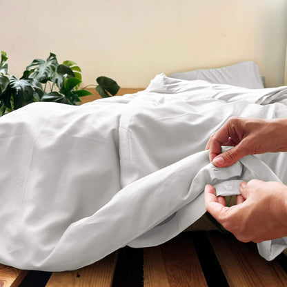 Close-up of buttons on white bamboo duvet – soft, breathable and sustainable bedding