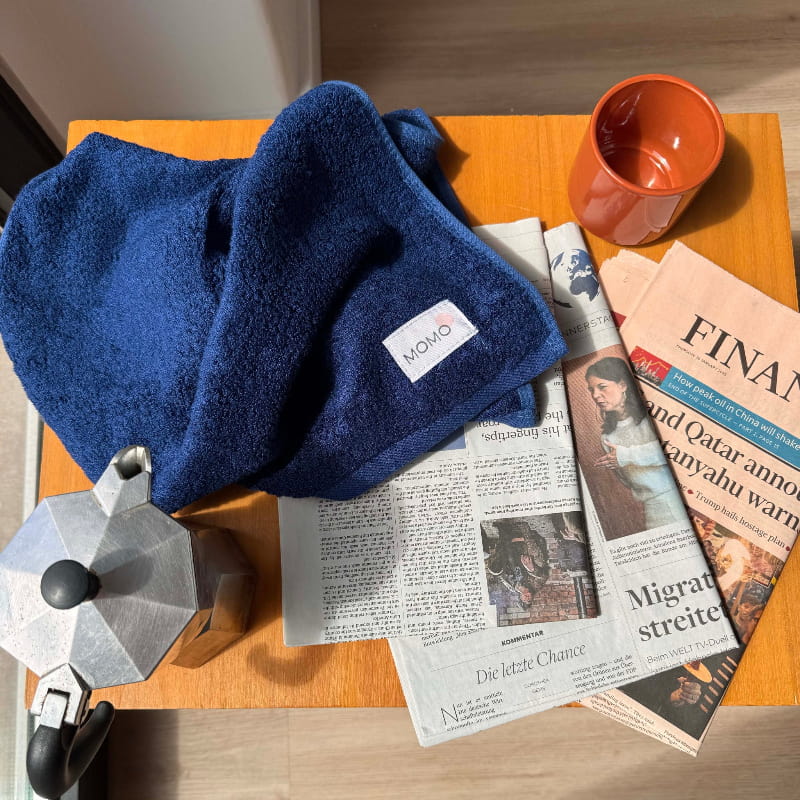 Close-up of blue bamboo hand towel on table – soft, absorbent and sustainable