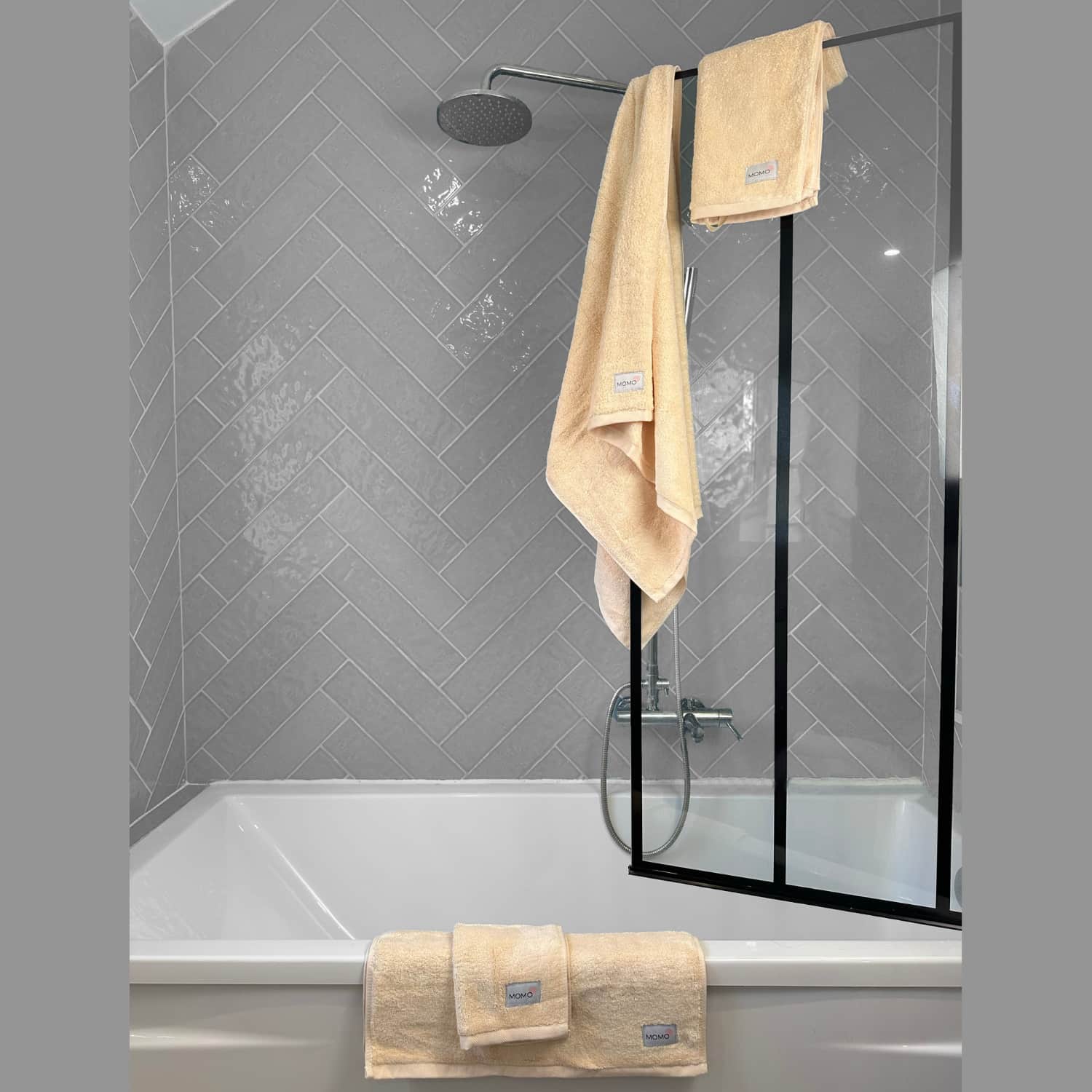 Complete beige bamboo towel set on shower – bath, hand and face towels, soft, absorbent and sustainable