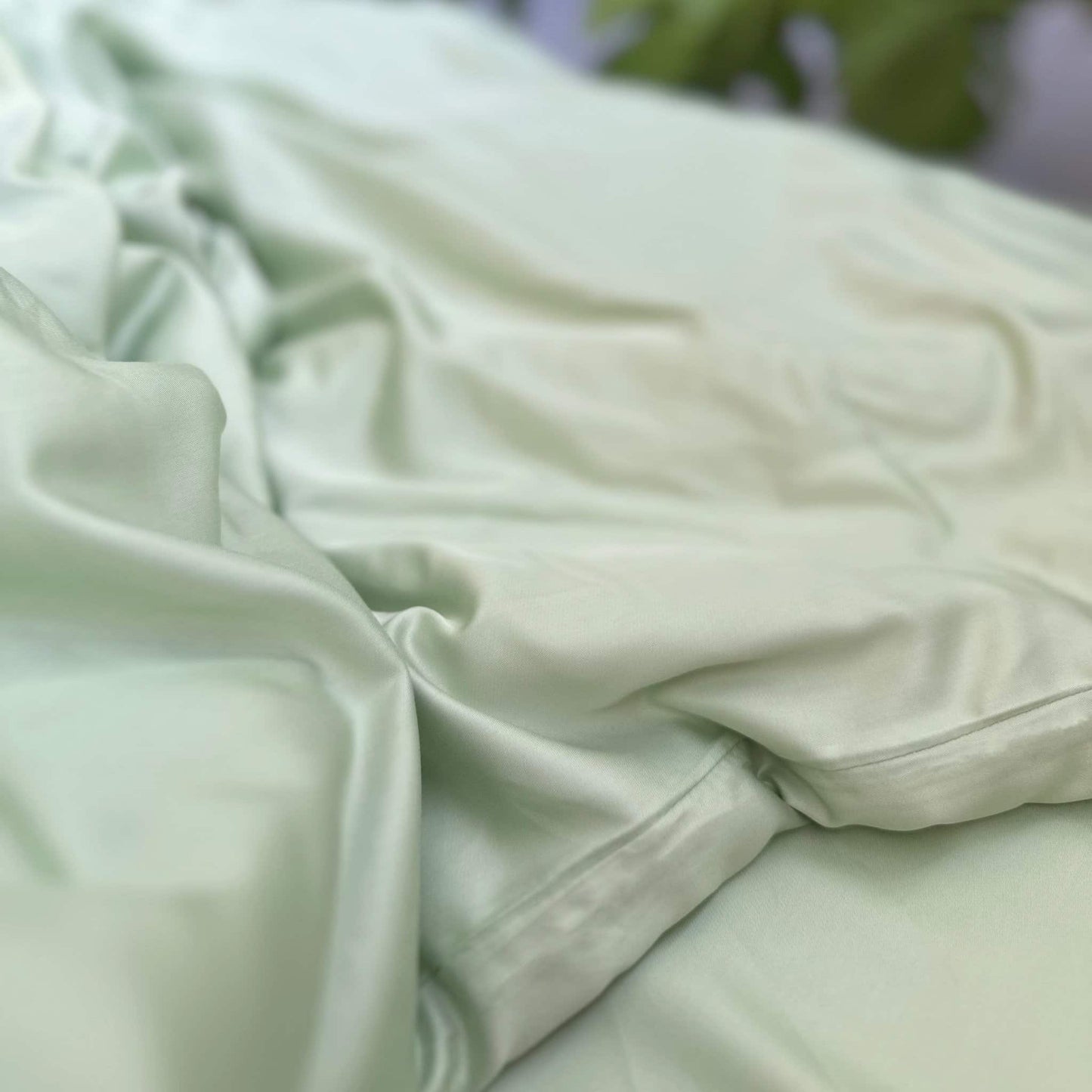 Close-up of green bamboo fabric texture – soft, breathable and sustainable bedding material