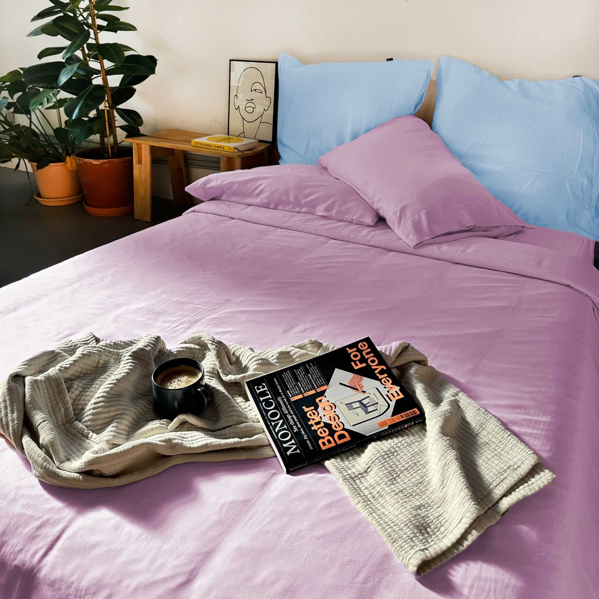 Light blue bamboo duvet with lavender pillows and magazine on bed – soft, breathable and sustainable bedding