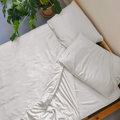 Top view of white bamboo duvet set – duvet and pillows, soft, breathable and sustainable bedding