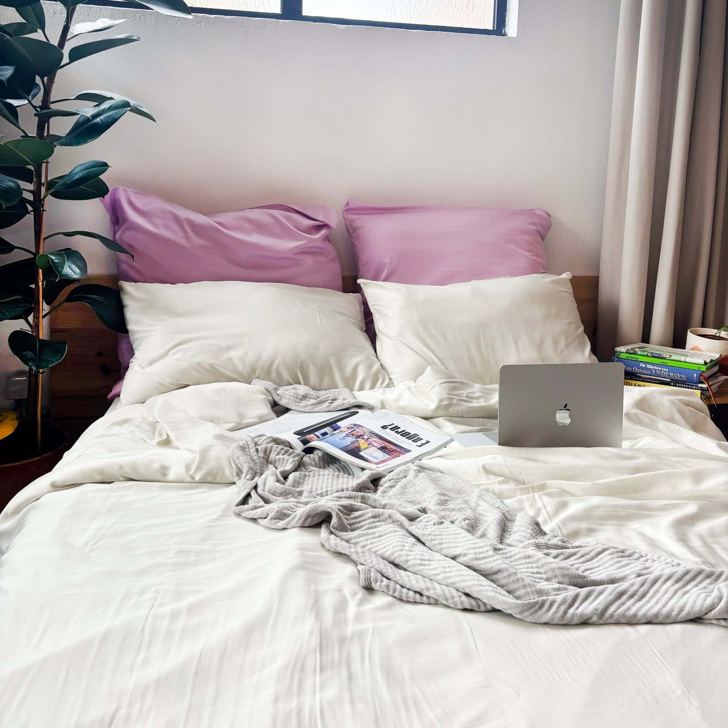 White, pearl and lilac bamboo duvet set with grey bamboo blanket on messy bed – soft, breathable and sustainable