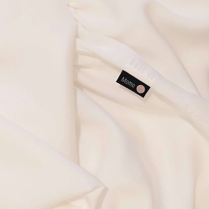 Close-up of label on pearl white bamboo sheet – soft, breathable and sustainable bedding