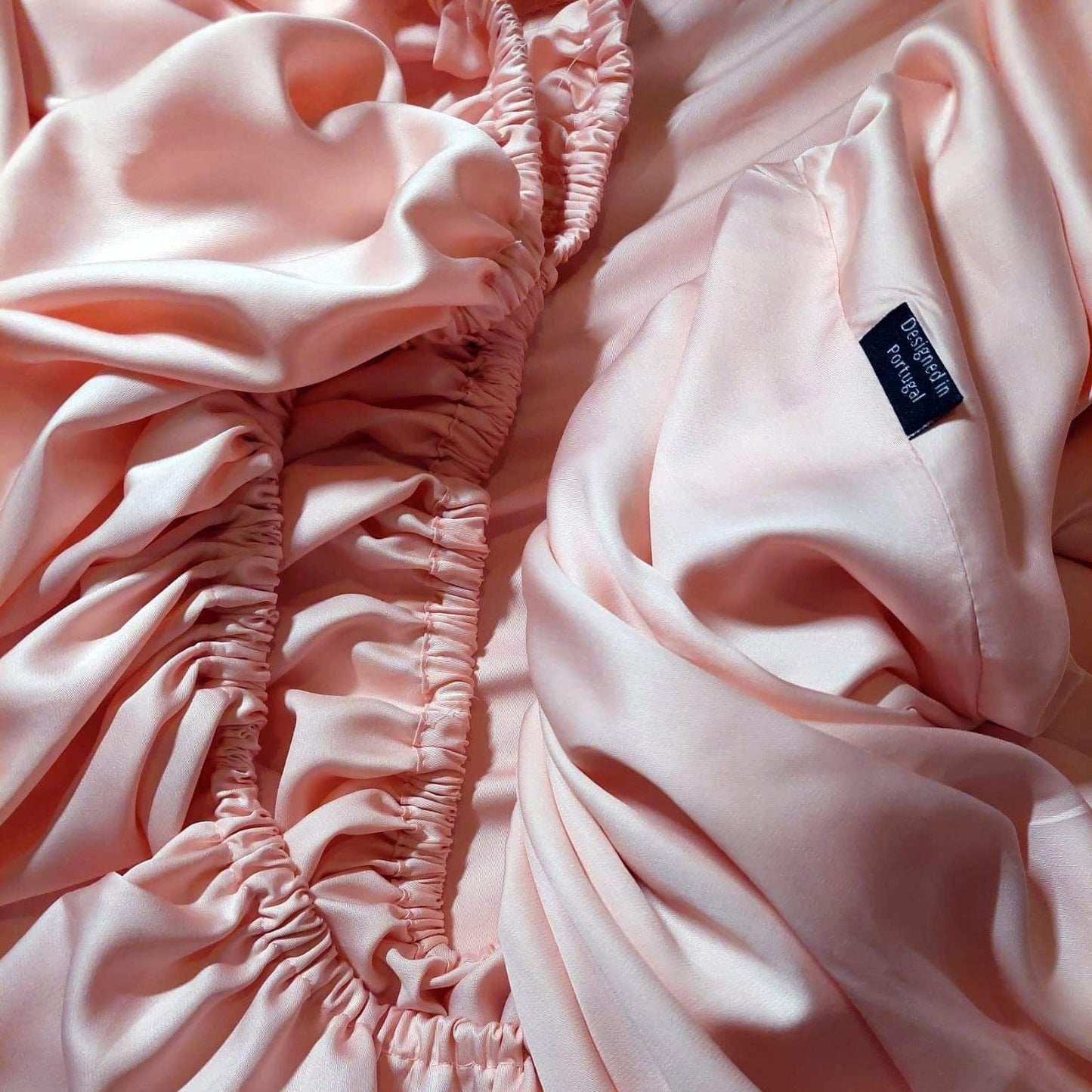 Close-up of label on pink bamboo fitted sheet – soft, breathable and sustainable bedding