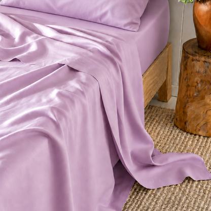 Sábana superior rosa de bambú satinado 300 hilos sobre cama de madera con almohada