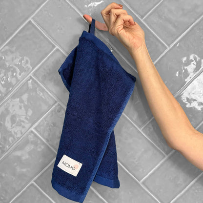Blue bamboo washcloth on grey background – soft, absorbent and sustainable
