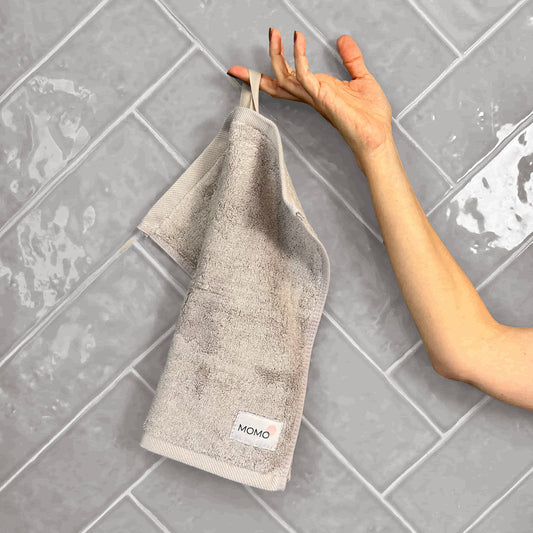 Grey bamboo washcloth on grey background – soft, absorbent and sustainable