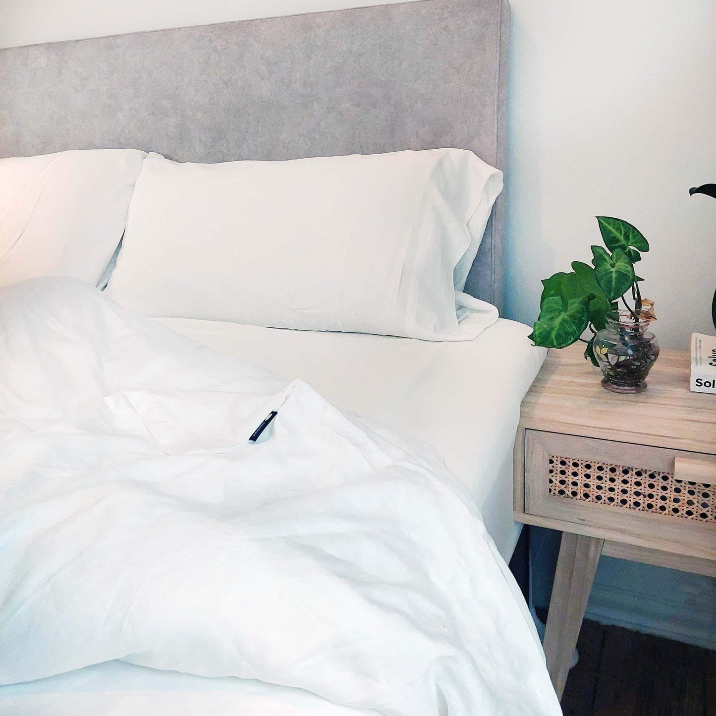 White bamboo duvet set on bed with side table – duvet and pillows, soft, breathable and sustainable bedding
